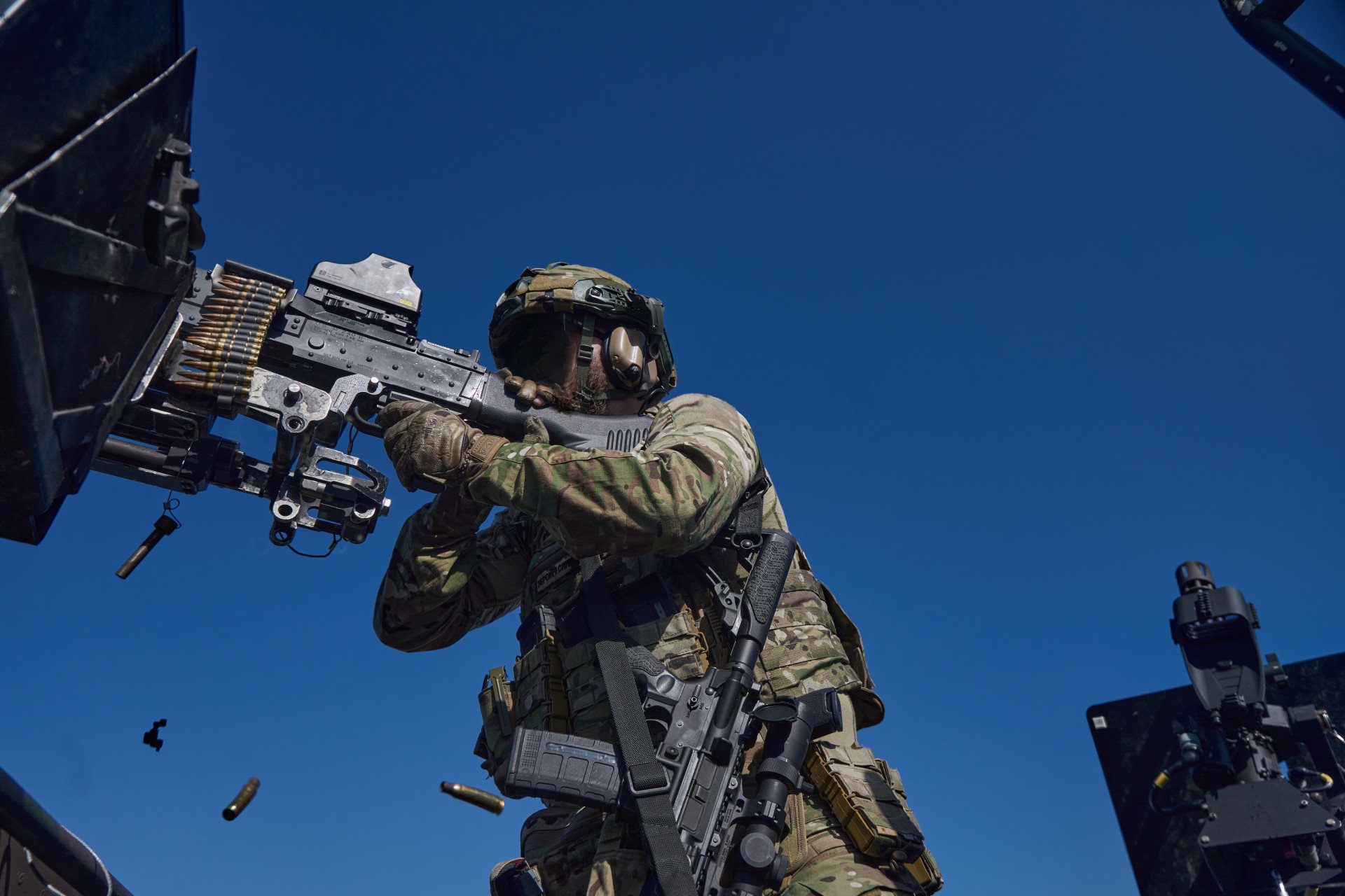 Before landing, SOF soldiers suppress enemy positions with all available weaponry to secure the unloading zone. Before landing, SOF soldiers suppress enemy positions with all available weaponry to secure the unloading zone.