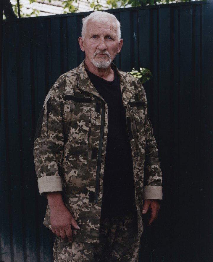 Valentyn, a resident and defender of Yablunska Street—once the site of intense battles and mass executions—stands in Bucha, Ukraine. May 2022. Photo: Joshua Olley. Valentyn, a resident and defender of Yablunska Street—once the site of intense battles and mass executions—stands in Bucha, Ukraine. May 2022. Photo: Joshua Olley.